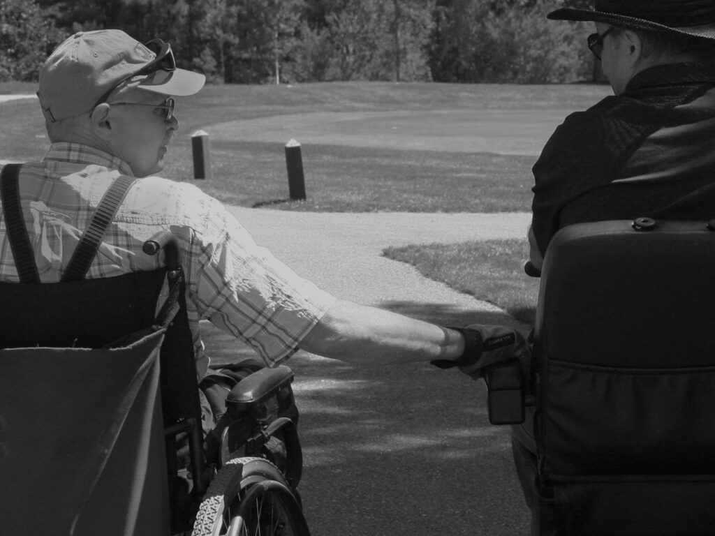 men in wheelchairs on golf course