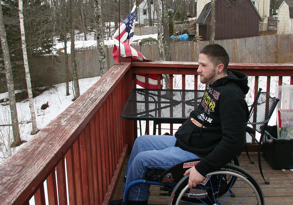 man in wheelchair on porch