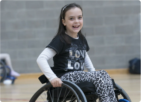 smiling child in refurbished wheelchair